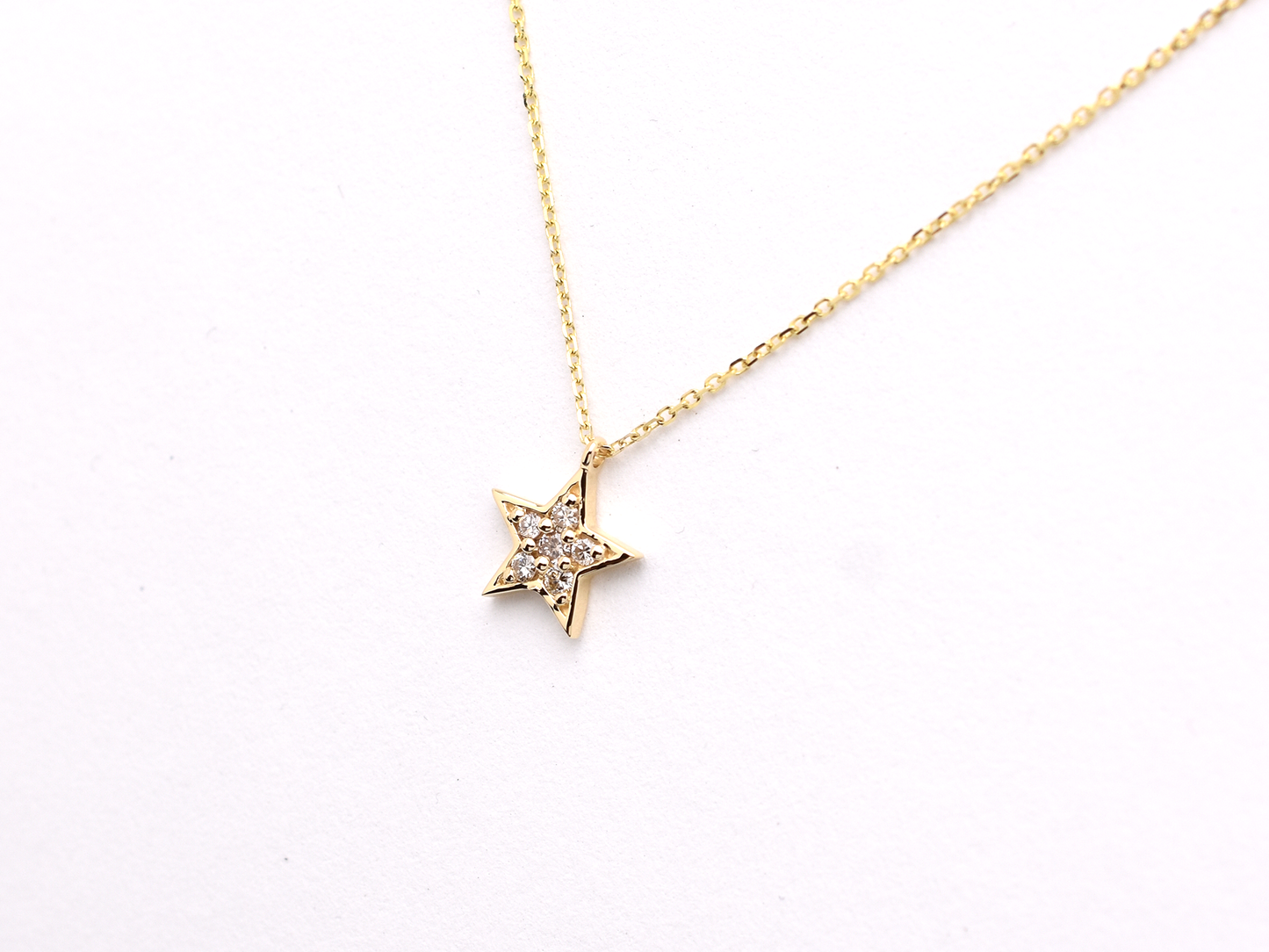 14k gold diamond star necklace styled for everyday elegance.