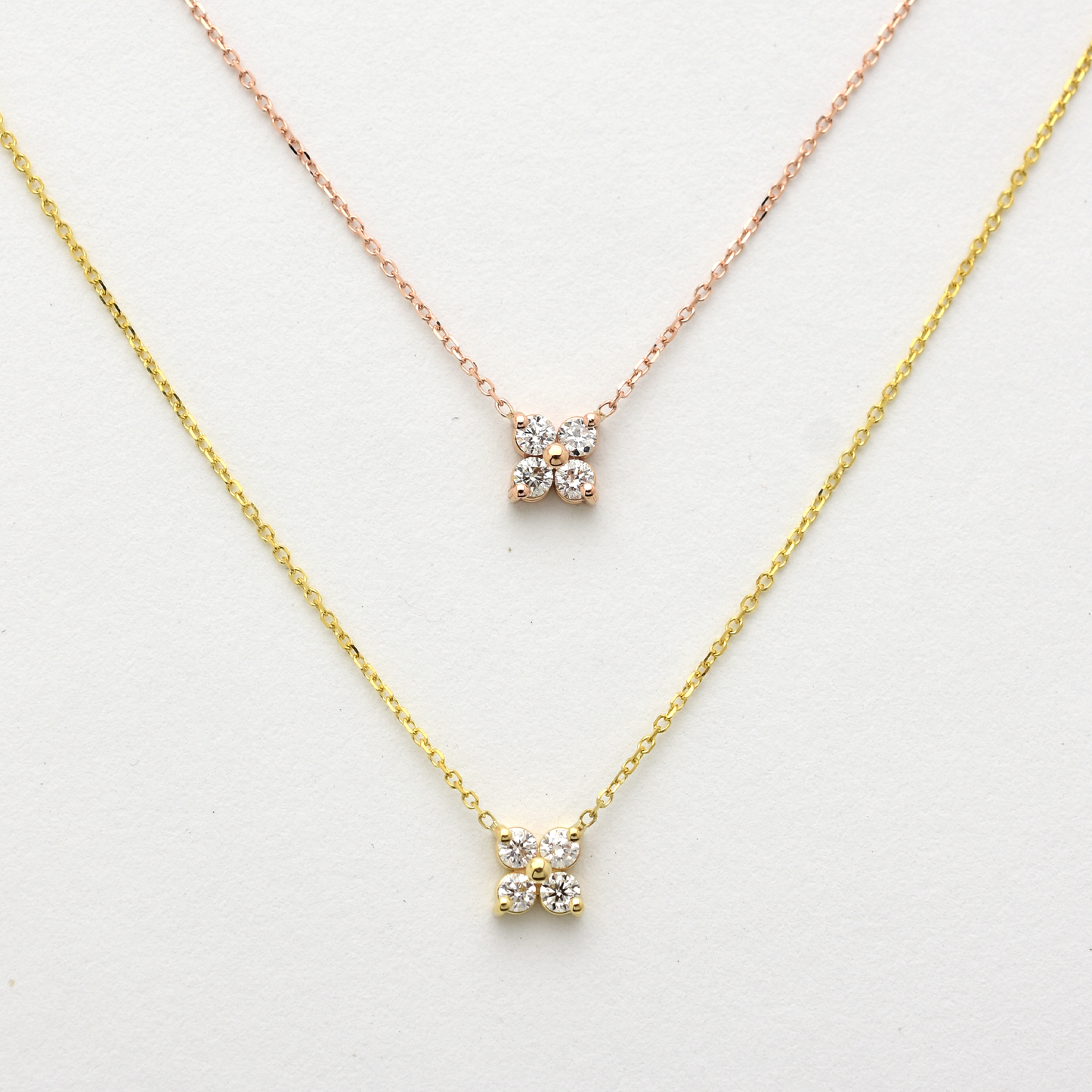 Two diamond necklaces on a white background