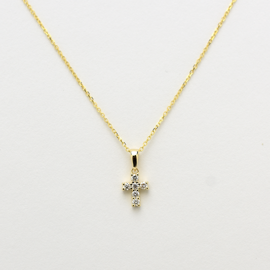 14K gold diamond cross pendant on display