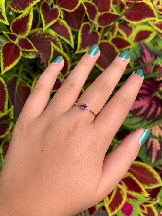 on hand 14k gold round-cut amethyst solitaire ring with slim gold band, dainty February birthstone jewelry